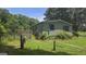 Exterior of a home featuring a fenced-in yard and mature landscaping at 1100 Kinnett Rd, Covington, GA 30016