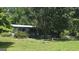 Cozy home featuring a covered porch and surrounded by mature trees at 1100 Kinnett Rd, Covington, GA 30016