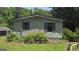 Side exterior view featuring gray shutters, landscaping, and privacy at 1100 Kinnett Rd, Covington, GA 30016