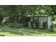 Charming single-story home with a screened-in porch and lush landscaping at 1100 Kinnett Rd, Covington, GA 30016