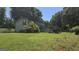 Exterior view showcasing a wooden deck and a spacious green lawn at 1100 Kinnett Rd, Covington, GA 30016
