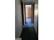 Hallway with doors leading to other rooms with green carpet at 1100 Kinnett Rd, Covington, GA 30016