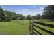 Picturesque view of property with fencing and lush greenery at 1100 Kinnett Rd, Covington, GA 30016
