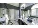 Bright bathroom featuring double sinks, glass enclosed shower and white tile at 9742 Fallview Ct, Villa Rica, GA 30180