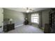 This bedroom has neutral carpet, windows with curtains and wood furniture at 9742 Fallview Ct, Villa Rica, GA 30180