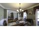 Elegant dining room with hardwood floors, chandelier, and decorative accents, perfect for formal dinners at 9742 Fallview Ct, Villa Rica, GA 30180
