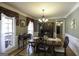 Traditional dining room featuring hardwood floors, an elegant chandelier, and a wooden dining set at 9742 Fallview Ct, Villa Rica, GA 30180
