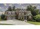 Charming two-story brick home with a well-manicured lawn, a two-car garage, and inviting front porch at 9742 Fallview Ct, Villa Rica, GA 30180