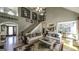 Open concept living room with a fireplace, staircase, and multiple seating areas at 9742 Fallview Ct, Villa Rica, GA 30180