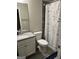 Bathroom with granite countertop, white cabinetry, modern fixtures, and gray ceramic tile shower at 3608 Davenport Rd, Duluth, GA 30096
