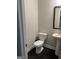 Half bath with dark floors, toilet and vanity at 3608 Davenport Rd, Duluth, GA 30096