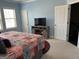 Comfortable bedroom with blue walls, TV, and closet doors at 3608 Davenport Rd, Duluth, GA 30096