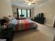 Bedroom with a ceiling fan, large bed, a desk and carpeted floors at 3608 Davenport Rd, Duluth, GA 30096