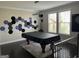 Game room with a covered pool table, dark hardwood floors, and modern decor at 3608 Davenport Rd, Duluth, GA 30096