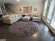 Open-concept living room featuring a comfortable sectional sofa and a round area rug at 3608 Davenport Rd, Duluth, GA 30096