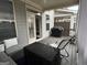 Covered outdoor porch with seating, grill, and entry door to the interior of the home at 3608 Davenport Rd, Duluth, GA 30096