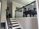 View of the home's staircase with dark wood banisters and gray walls at 3608 Davenport Rd, Duluth, GA 30096