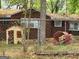 View of fenced-in backyard showing assorted play equipment near brick home at 957 Astor Ave, Forest Park, GA 30297