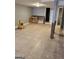 Unfinished basement area features tile floors, gray walls, a utility sink, and access to storage at 957 Astor Ave, Forest Park, GA 30297