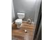 Tight shot of toilet and bathroom in need of repairs featuring old floors, and old fixtures at 957 Astor Ave, Forest Park, GA 30297