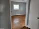 Bedroom features hardwood floors, gray walls, and a window offering natural light at 957 Astor Ave, Forest Park, GA 30297