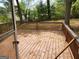 View of the wooden deck in the backyard surrounded by lush greenery at 957 Astor Ave, Forest Park, GA 30297