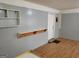 Entryway features gray walls, a wooden floor, wall shelving, and a coat rack for added convenience at 957 Astor Ave, Forest Park, GA 30297