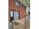 Brick home exterior featuring a side entrance, with black door, and gray siding at 957 Astor Ave, Forest Park, GA 30297