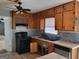 The kitchen features wooden cabinets, a black stove, and a double basin sink at 957 Astor Ave, Forest Park, GA 30297