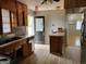 Kitchen with wood cabinets, laminate floors, and stainless steel appliances at 957 Astor Ave, Forest Park, GA 30297