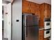 This kitchen has stainless steel appliances and beautiful wooden cabinets at 957 Astor Ave, Forest Park, GA 30297