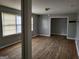 The living room features hardwood floors, gray walls, and two windows with blinds at 957 Astor Ave, Forest Park, GA 30297