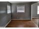 Empty room features wood floors, gray walls and window with blinds at 957 Astor Ave, Forest Park, GA 30297