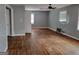 Living room with gray walls, hardwood floors, and natural light from multiple windows at 957 Astor Ave, Forest Park, GA 30297