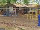 View of the fenced in playground with equipment in the yard of the home at 957 Astor Ave, Forest Park, GA 30297