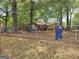 The backyard features a fenced playground area with various play structures at 957 Astor Ave, Forest Park, GA 30297