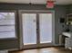 Versatile room featuring wood floors, ample light, sink with cabinet, and convenient exit doors at 957 Astor Ave, Forest Park, GA 30297