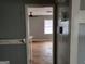 View of an empty room with hardwood floors through a doorway at 957 Astor Ave, Forest Park, GA 30297