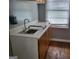 Functional space includes a sink with cabinets, a large window, and durable wood floors at 957 Astor Ave, Forest Park, GA 30297