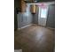 An empty room features tile floors, painted walls and some cabinets and a white door with an exit sign above it at 957 Astor Ave, Forest Park, GA 30297