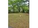 Lush green yard with mature trees and natural landscaping, creating a serene outdoor space at 957 Astor Ave, Forest Park, GA 30297