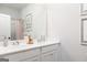 Well-lit bathroom featuring double sinks, white cabinets, and a large mirror for a sleek design at 602 Belshire Dr, Acworth, GA 30102