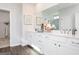 Elegant bathroom with double vanity, white cabinets, and a large mirror with decorative accents at 602 Belshire Dr, Acworth, GA 30102
