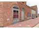 A historic brick building showcasing arched doorways and windows, with a vintage charm along a brick-paved walkway at 602 Belshire Dr, Acworth, GA 30102