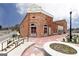 A historic brick building with large arched windows features vintage charm, enhanced by a decorative walkway and street lamps at 602 Belshire Dr, Acworth, GA 30102
