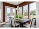 Dining room boasts a view of the back yard, a long table with chairs, and stylish modern lighting at 602 Belshire Dr, Acworth, GA 30102