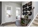 Inviting home foyer with hardwood floors, open staircase, and a glimpse of the bedroom at 602 Belshire Dr, Acworth, GA 30102