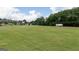 Well manicured green space with trees and other community buildings in the distance at 602 Belshire Dr, Acworth, GA 30102