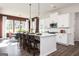Kitchen features a large central island, white cabinetry, stainless steel appliances, and view into eat-in nook at 602 Belshire Dr, Acworth, GA 30102