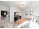 Comfortable main bedroom with neutral colors, a modern chandelier, and a view into the hall at 602 Belshire Dr, Acworth, GA 30102